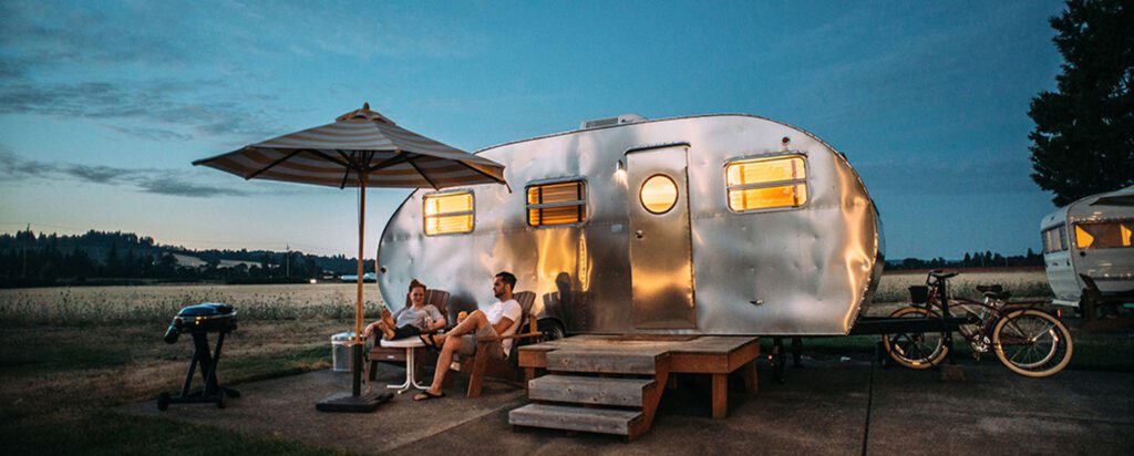 camping-couple-airstream-nighttime-advertising